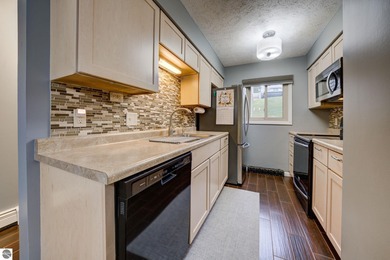 This turnkey lower level condo on 6th fairway of The Crown Golf on Bay Meadows Golf Course - Executive in Michigan - for sale on GolfHomes.com, golf home, golf lot