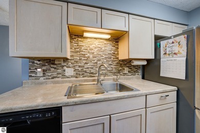 This turnkey lower level condo on 6th fairway of The Crown Golf on Bay Meadows Golf Course - Executive in Michigan - for sale on GolfHomes.com, golf home, golf lot