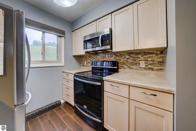 This turnkey lower level condo on 6th fairway of The Crown Golf on Bay Meadows Golf Course - Executive in Michigan - for sale on GolfHomes.com, golf home, golf lot