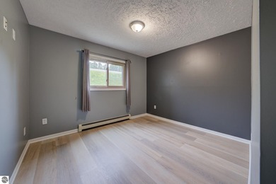 This turnkey lower level condo on 6th fairway of The Crown Golf on Bay Meadows Golf Course - Executive in Michigan - for sale on GolfHomes.com, golf home, golf lot