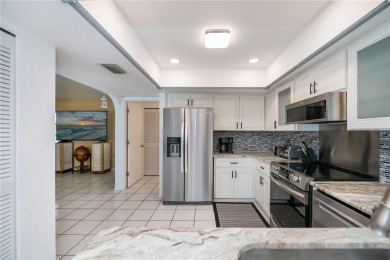 BEAUTIFULLY UPDATED POOL HOME on a large private, oversized on Pinemoor West Golf Club in Florida - for sale on GolfHomes.com, golf home, golf lot
