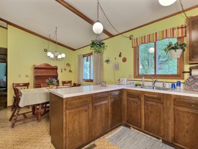 Explore a meticulously maintained 3-bedroom, 1.5-bathroom home on Plum Lake Golf Club in Wisconsin - for sale on GolfHomes.com, golf home, golf lot