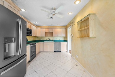Experience timeless comfort and sweeping double fairway views in on Quail Ridge Golf Course and Country Club in Florida - for sale on GolfHomes.com, golf home, golf lot