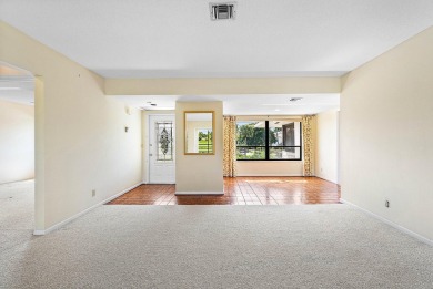 Experience timeless comfort and sweeping double fairway views in on Quail Ridge Golf Course and Country Club in Florida - for sale on GolfHomes.com, golf home, golf lot