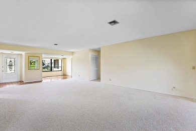 Experience timeless comfort and sweeping double fairway views in on Quail Ridge Golf Course and Country Club in Florida - for sale on GolfHomes.com, golf home, golf lot