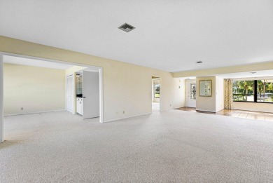 Experience timeless comfort and sweeping double fairway views in on Quail Ridge Golf Course and Country Club in Florida - for sale on GolfHomes.com, golf home, golf lot
