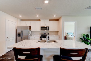 Discover this stunning lake-view home on a spacious corner lot! on Grand Reserve Golf Course in Florida - for sale on GolfHomes.com, golf home, golf lot