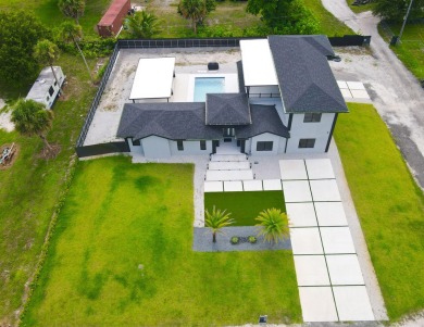 Prepare to be wowed by this magnificent 2-story home on an on Okeeheelee Golf Course in Florida - for sale on GolfHomes.com, golf home, golf lot