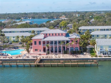 Sporting pastel-colored, Bermuda-styled exteriors, this on St. Petersburg Country Club in Florida - for sale on GolfHomes.com, golf home, golf lot