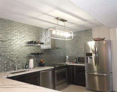 A rarity and a real beauty. Chic best describes this townhome on Holly Lake Ranch Golf Club in Texas - for sale on GolfHomes.com, golf home, golf lot