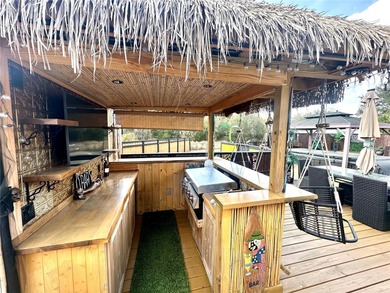 Step into your very own tropical oasis! This backyard is on The Links of Spruce Creek in Florida - for sale on GolfHomes.com, golf home, golf lot