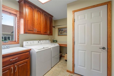 Experience the best of one-level living with peaceful lake views on TPC of the Twin Cities in Minnesota - for sale on GolfHomes.com, golf home, golf lot