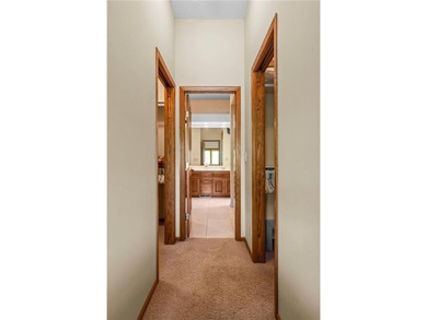 Experience the best of one-level living with peaceful lake views on TPC of the Twin Cities in Minnesota - for sale on GolfHomes.com, golf home, golf lot