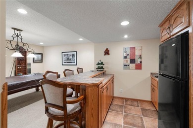 Experience the best of one-level living with peaceful lake views on TPC of the Twin Cities in Minnesota - for sale on GolfHomes.com, golf home, golf lot