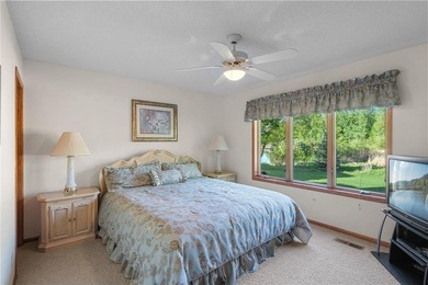 Experience the best of one-level living with peaceful lake views on TPC of the Twin Cities in Minnesota - for sale on GolfHomes.com, golf home, golf lot