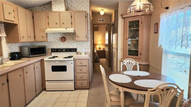 TWO BED, ONE BATH HOME IN ACTIVE 55+ COMMUNITY! This furnished on River Run Golf Links in Florida - for sale on GolfHomes.com, golf home, golf lot