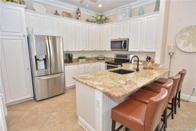 This Bermuda with it's inviting front porch and open-kitchen on The Florida Club in Florida - for sale on GolfHomes.com, golf home, golf lot