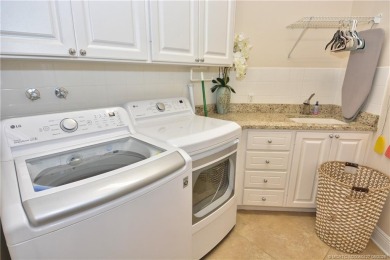 This Bermuda with it's inviting front porch and open-kitchen on The Florida Club in Florida - for sale on GolfHomes.com, golf home, golf lot