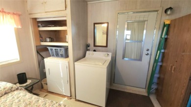 TWO BED, ONE BATH HOME IN ACTIVE 55+ COMMUNITY! This furnished on River Run Golf Links in Florida - for sale on GolfHomes.com, golf home, golf lot