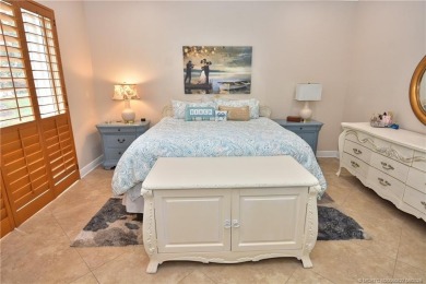 This Bermuda with it's inviting front porch and open-kitchen on The Florida Club in Florida - for sale on GolfHomes.com, golf home, golf lot