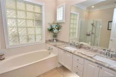 This Bermuda with it's inviting front porch and open-kitchen on The Florida Club in Florida - for sale on GolfHomes.com, golf home, golf lot