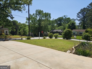 No HOA - Discover the perfect blend of contemporary elegance and on Charlie Yates Golf Course in Georgia - for sale on GolfHomes.com, golf home, golf lot
