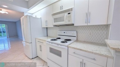 Embrace the vibrant 55+ lifestyle in South Florida's best-kept on Wynmoor Golf Course in Florida - for sale on GolfHomes.com, golf home, golf lot