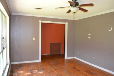 Spacious and full of potential, this 4-bedroom, 2-bathroom home on Jake Gaither Golf Course in Florida - for sale on GolfHomes.com, golf home, golf lot