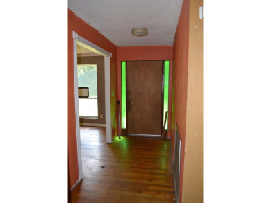 Spacious and full of potential, this 4-bedroom, 2-bathroom home on Jake Gaither Golf Course in Florida - for sale on GolfHomes.com, golf home, golf lot