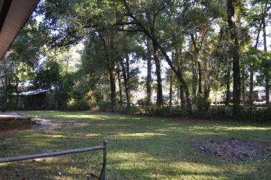 Spacious and full of potential, this 4-bedroom, 2-bathroom home on Jake Gaither Golf Course in Florida - for sale on GolfHomes.com, golf home, golf lot
