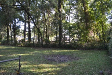 Spacious and full of potential, this 4-bedroom, 2-bathroom home on Jake Gaither Golf Course in Florida - for sale on GolfHomes.com, golf home, golf lot