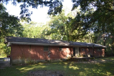 Spacious and full of potential, this 4-bedroom, 2-bathroom home on Jake Gaither Golf Course in Florida - for sale on GolfHomes.com, golf home, golf lot