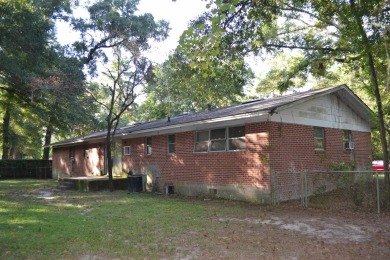 Spacious and full of potential, this 4-bedroom, 2-bathroom home on Jake Gaither Golf Course in Florida - for sale on GolfHomes.com, golf home, golf lot