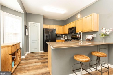 Welcome to this beautifully maintained three-level end-unit on Sugar Hill Golf Club in Georgia - for sale on GolfHomes.com, golf home, golf lot