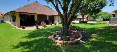 Nestled in a beautifully landscaped setting and shaded by mature on Wildhorse Golf Club of Robson Ranch in Texas - for sale on GolfHomes.com, golf home, golf lot