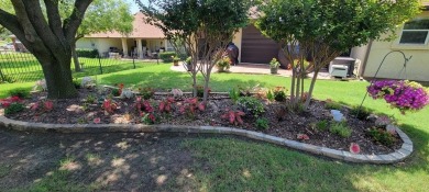 Nestled in a beautifully landscaped setting and shaded by mature on Wildhorse Golf Club of Robson Ranch in Texas - for sale on GolfHomes.com, golf home, golf lot