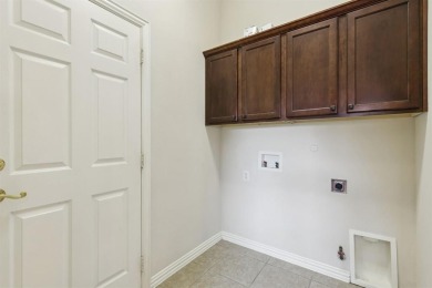 Nestled in a beautifully landscaped setting and shaded by mature on Wildhorse Golf Club of Robson Ranch in Texas - for sale on GolfHomes.com, golf home, golf lot