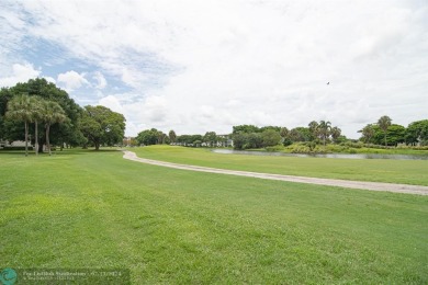 Step into the epitome of serene living with this delightful on Wynmoor Golf Course in Florida - for sale on GolfHomes.com, golf home, golf lot