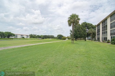 Step into the epitome of serene living with this delightful on Wynmoor Golf Course in Florida - for sale on GolfHomes.com, golf home, golf lot