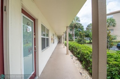 Step into the epitome of serene living with this delightful on Wynmoor Golf Course in Florida - for sale on GolfHomes.com, golf home, golf lot