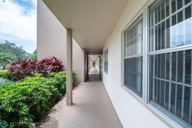 Step into the epitome of serene living with this delightful on Wynmoor Golf Course in Florida - for sale on GolfHomes.com, golf home, golf lot