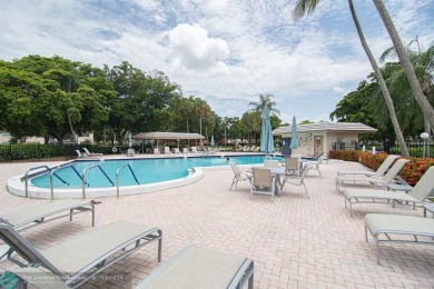 Step into the epitome of serene living with this delightful on Wynmoor Golf Course in Florida - for sale on GolfHomes.com, golf home, golf lot