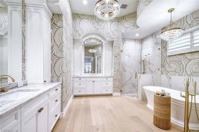 Nestled within the prestigious Pelican Marsh, this recently on Pelican Marsh Golf Club in Florida - for sale on GolfHomes.com, golf home, golf lot