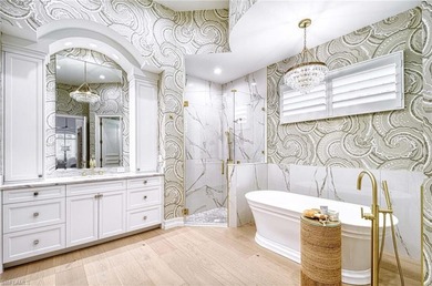 Nestled within the prestigious Pelican Marsh, this recently on Pelican Marsh Golf Club in Florida - for sale on GolfHomes.com, golf home, golf lot