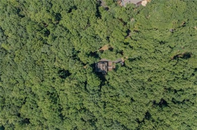 Nestled in a serene natural setting, this breathtaking 3-story on Big Canoe Golf Club - Cherokee in Georgia - for sale on GolfHomes.com, golf home, golf lot