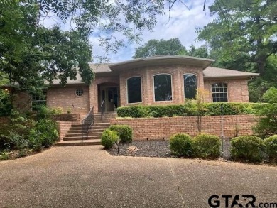 Set on a beautifully landscaped, oversized, 1 plus acre lot on Hide-A-Way Lake Golf Course in Texas - for sale on GolfHomes.com, golf home, golf lot