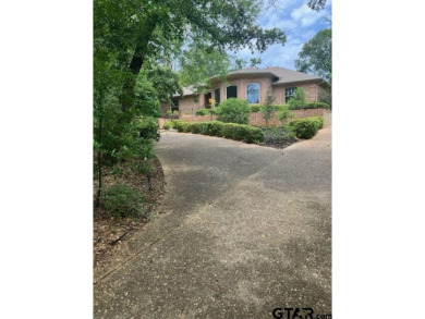 Set on a beautifully landscaped, oversized, 1 plus acre lot on Hide-A-Way Lake Golf Course in Texas - for sale on GolfHomes.com, golf home, golf lot