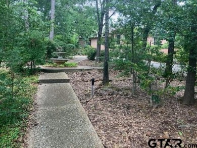Set on a beautifully landscaped, oversized, 1 plus acre lot on Hide-A-Way Lake Golf Course in Texas - for sale on GolfHomes.com, golf home, golf lot