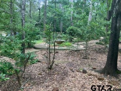 Set on a beautifully landscaped, oversized, 1 plus acre lot on Hide-A-Way Lake Golf Course in Texas - for sale on GolfHomes.com, golf home, golf lot
