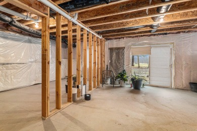 Welcome to this spacious 4-bedroom, 2.5-bath set on nearly half on Lake Doster Golf Club in Michigan - for sale on GolfHomes.com, golf home, golf lot
